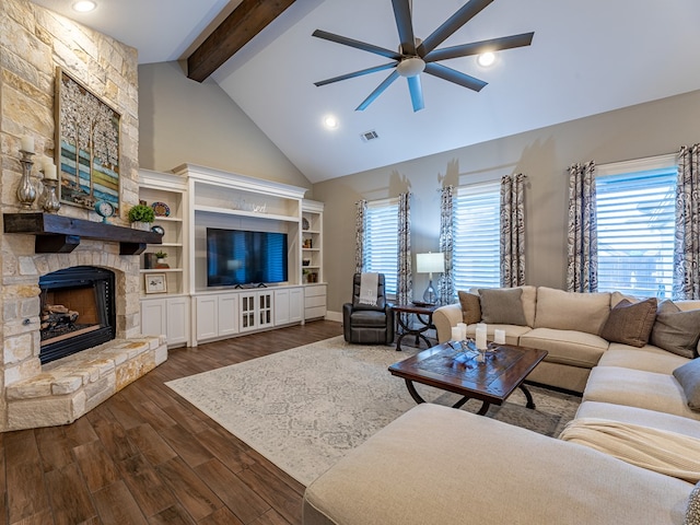 living area featuring ceiling fan, a stone fireplace, beam ceiling, visible vents, and dark wood-type flooring
