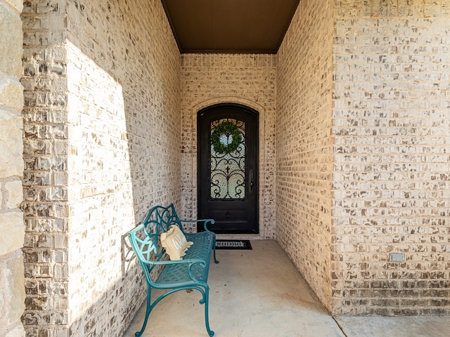 property entrance with brick siding