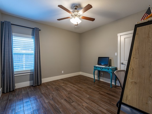 unfurnished office featuring dark wood-style floors, baseboards, and a ceiling fan