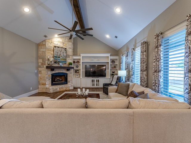 living area with beamed ceiling, a fireplace, high vaulted ceiling, a ceiling fan, and wood finished floors