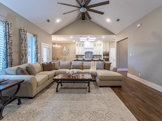 living area with recessed lighting, ceiling fan with notable chandelier, visible vents, and dark wood finished floors