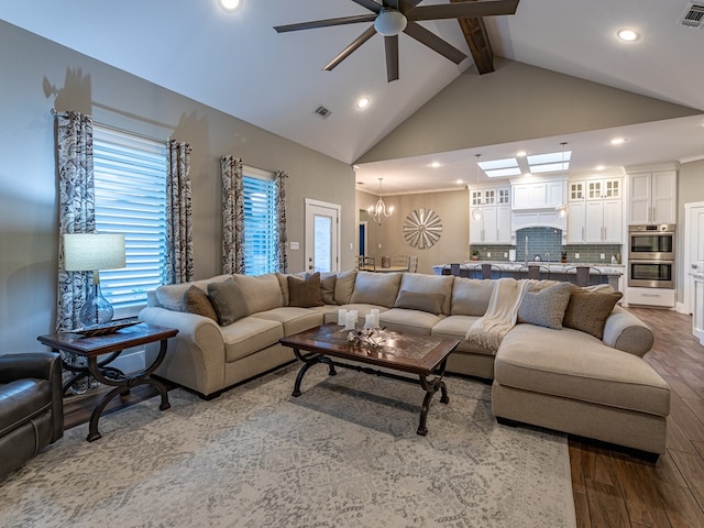 living area with recessed lighting, vaulted ceiling with beams, visible vents, wood finished floors, and ceiling fan with notable chandelier