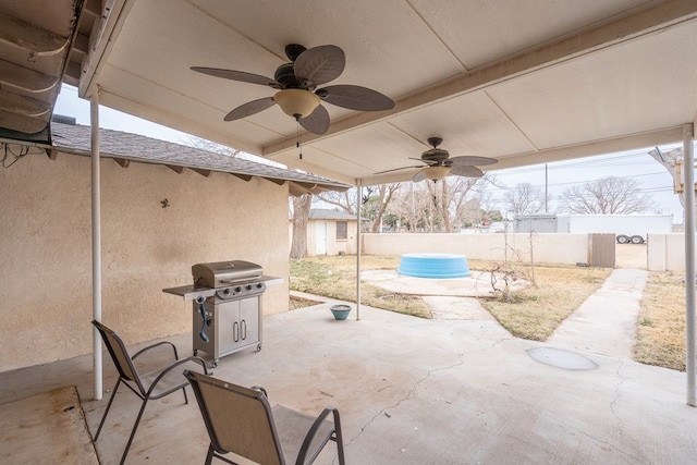 view of patio featuring a pool, ceiling fan, and a grill