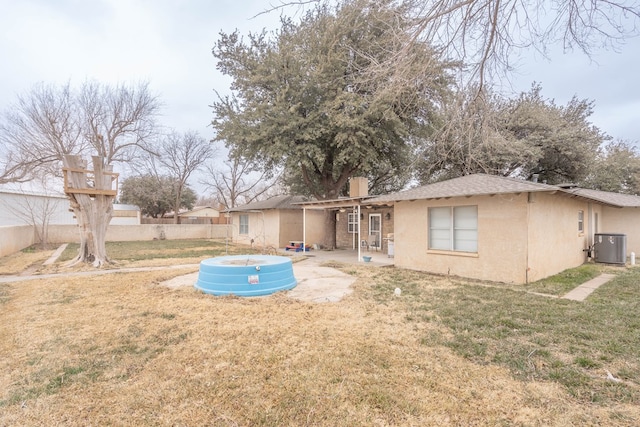 back of property featuring a patio area, central air condition unit, and a lawn