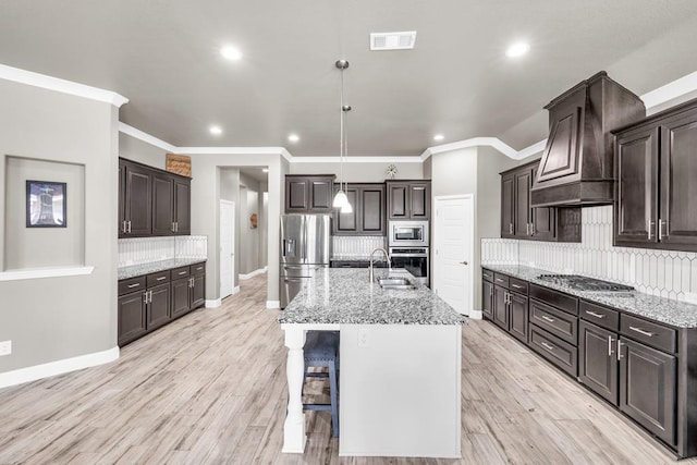 kitchen with appliances with stainless steel finishes, baseboards, tasteful backsplash, dark brown cabinets, and light stone counters