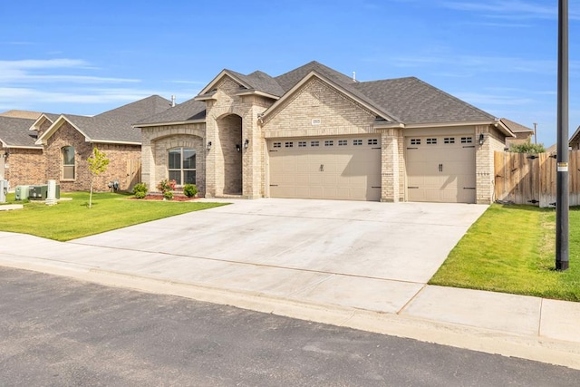 view of front facade featuring a garage, roof with shingles, driveway, brick siding, and central AC unit