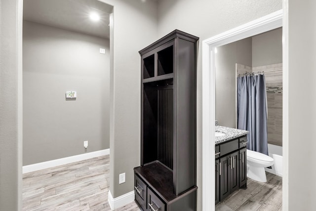 mudroom with light wood-style flooring and baseboards