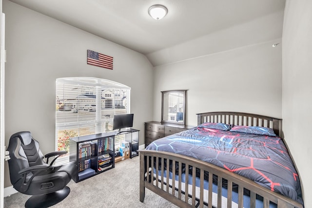 carpeted bedroom with vaulted ceiling and multiple windows