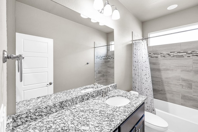 bathroom featuring toilet, vanity, and shower / bath combo