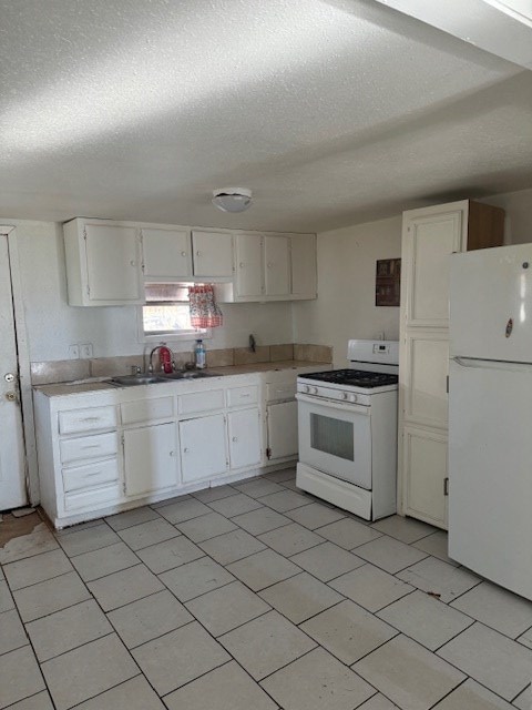 kitchen featuring white cabinetry, sink, white appliances, and a textured ceiling