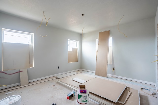 spare room featuring baseboards