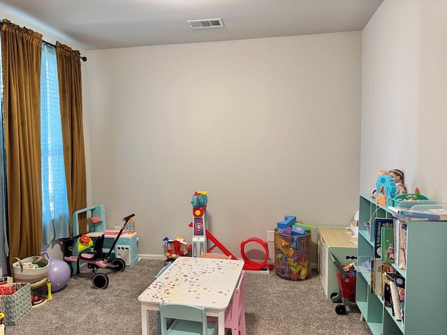 recreation room featuring a wealth of natural light, carpet, and visible vents