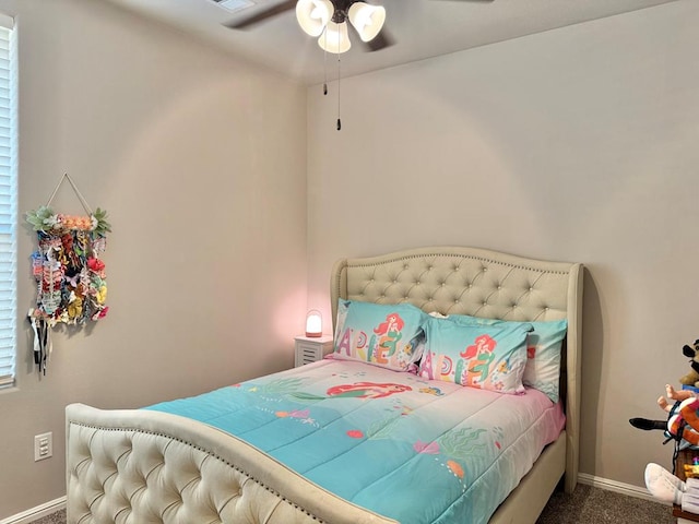 carpeted bedroom with a ceiling fan, visible vents, and baseboards