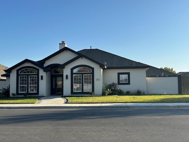 ranch-style home with a front lawn