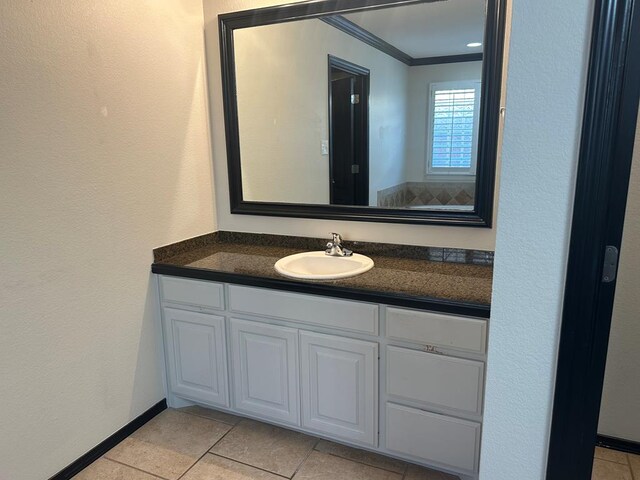 bathroom featuring tile patterned flooring, vanity, and ornamental molding