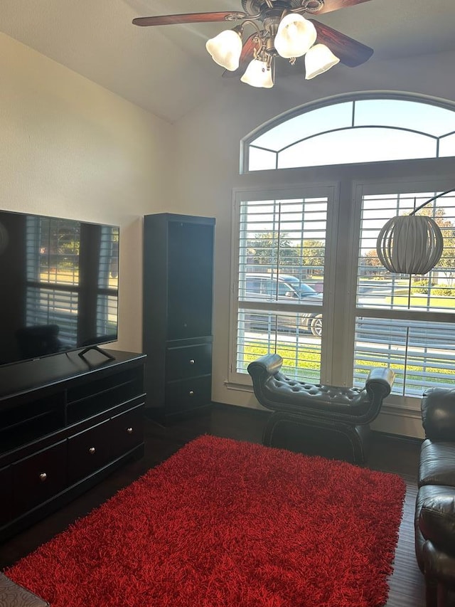 bedroom with dark hardwood / wood-style floors, vaulted ceiling, and ceiling fan