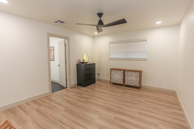 empty room featuring ceiling fan and light hardwood / wood-style floors