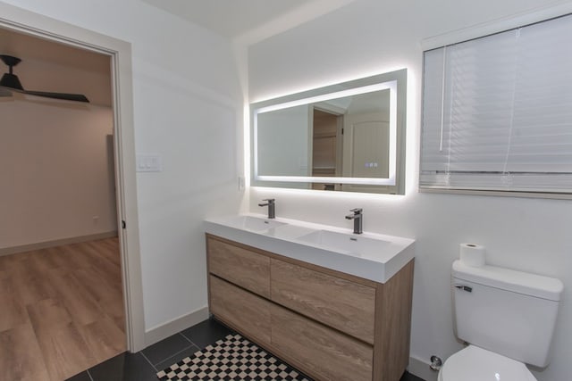 bathroom featuring vanity, hardwood / wood-style floors, and toilet