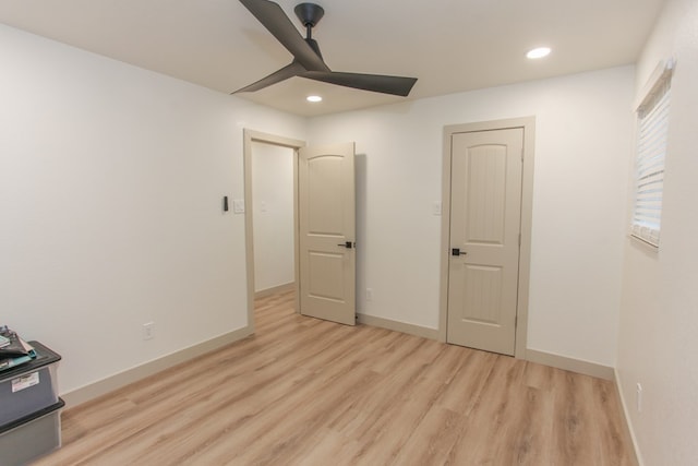 unfurnished bedroom with light hardwood / wood-style floors and ceiling fan