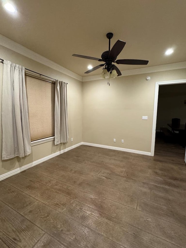 empty room with dark hardwood / wood-style flooring, ornamental molding, and ceiling fan