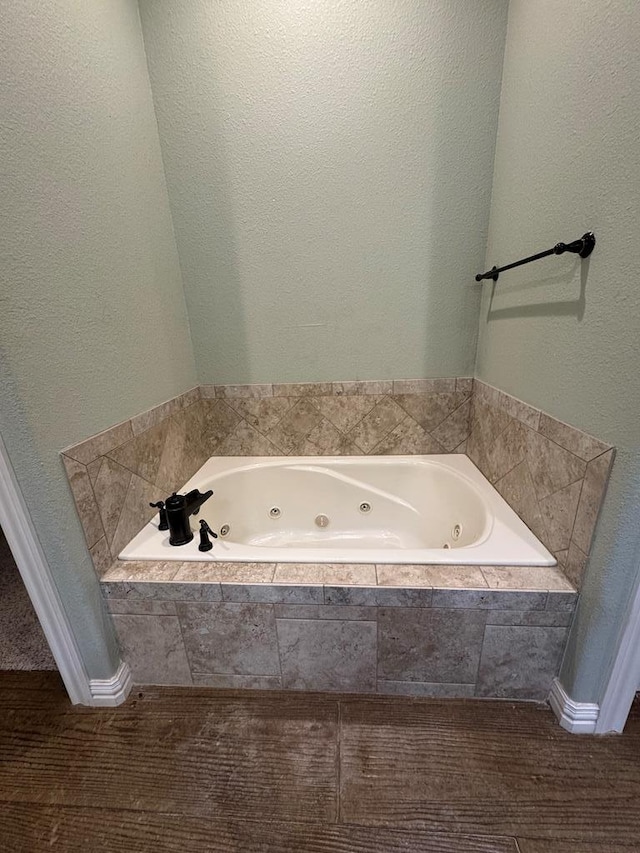 bathroom with tiled bath