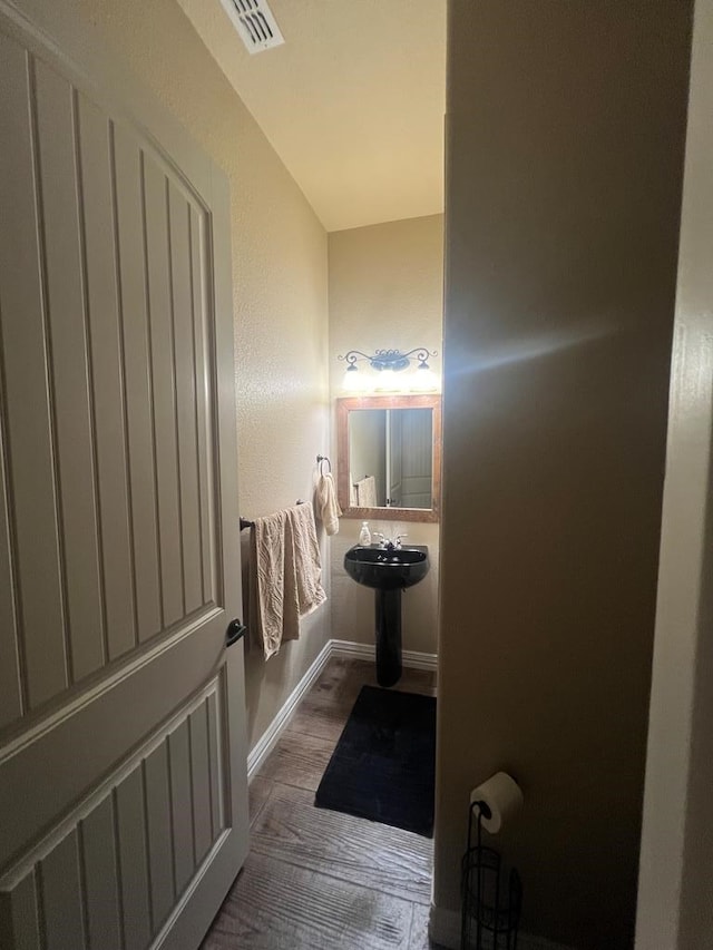 bathroom with hardwood / wood-style flooring