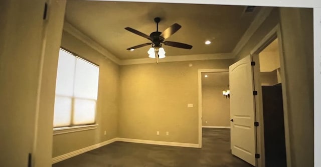 spare room featuring crown molding and ceiling fan