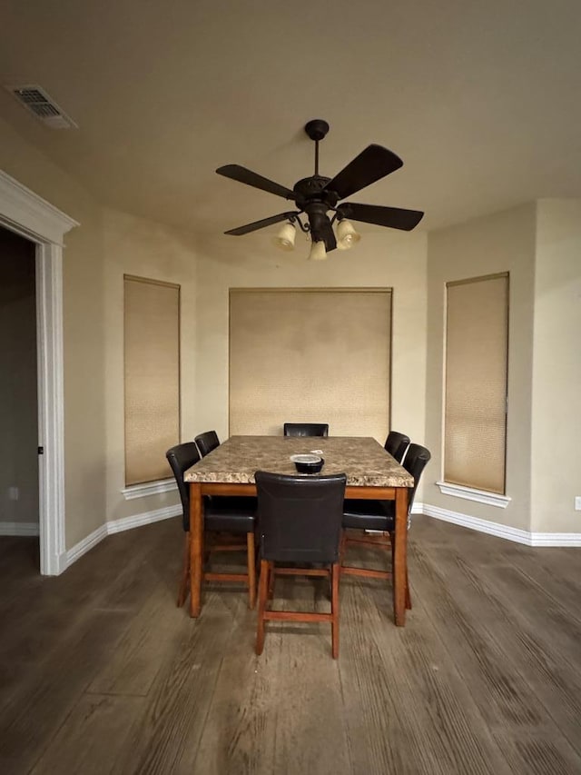 dining area with dark hardwood / wood-style flooring and ceiling fan