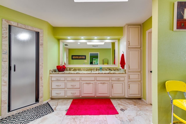 bathroom featuring a stall shower, vanity, baseboards, and marble finish floor