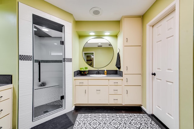 full bathroom featuring vanity, a shower stall, and wood finished floors