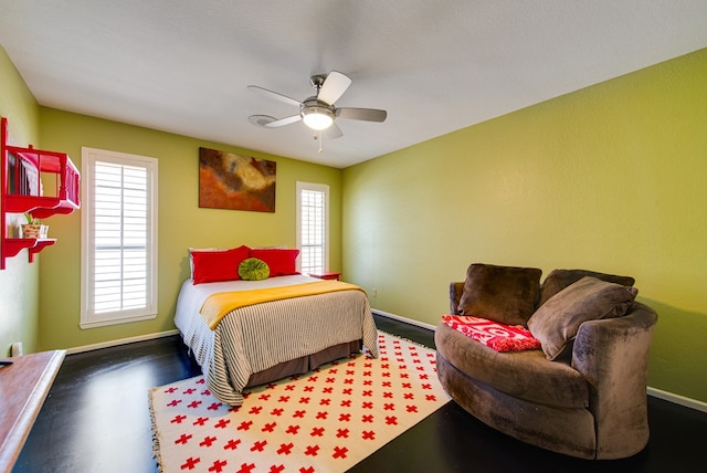 bedroom featuring baseboards and ceiling fan