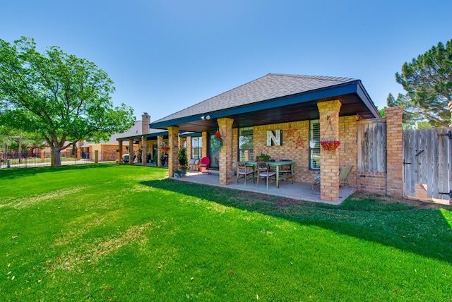 back of house with a yard, fence, and a patio area
