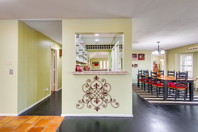 interior space featuring a notable chandelier, baseboards, and recessed lighting