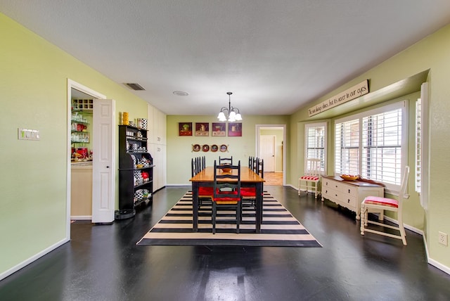 dining room with baseboards, a notable chandelier, and visible vents