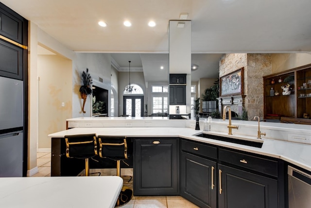 kitchen featuring hanging light fixtures, sink, light tile patterned floors, dishwasher, and fridge