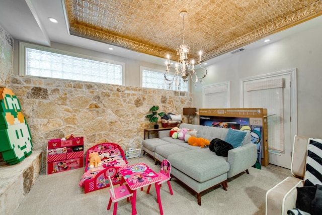 carpeted bedroom featuring an inviting chandelier and a raised ceiling