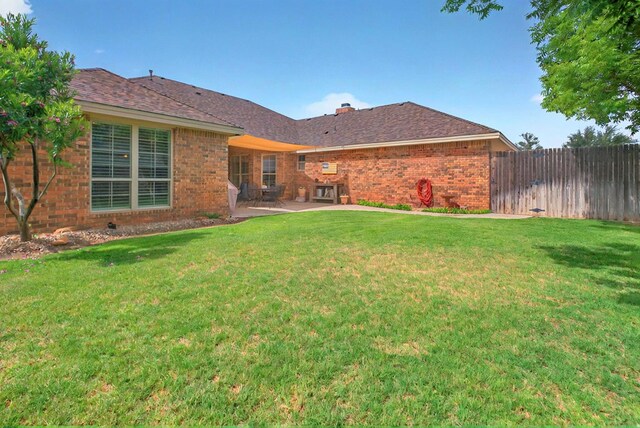 1302 Telluride Dr, Midland, TX 79705 - back of house featuring brick siding, a patio area, and a chimney
