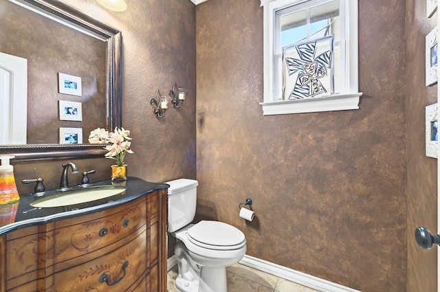 1302 Telluride Dr, Midland, TX 79705 - bathroom featuring vanity, toilet, tile patterned flooring, and baseboards