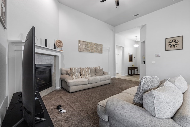 7104 Mcpherson Ln, Midland, TX 79706 - carpeted living room featuring a fireplace and a ceiling fan