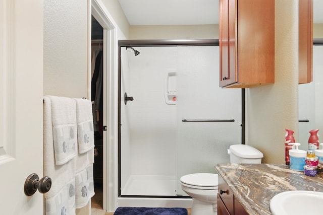 1601 Monterrey Dr, Midland, TX 79703 - bathroom featuring a stall shower, vanity, and toilet