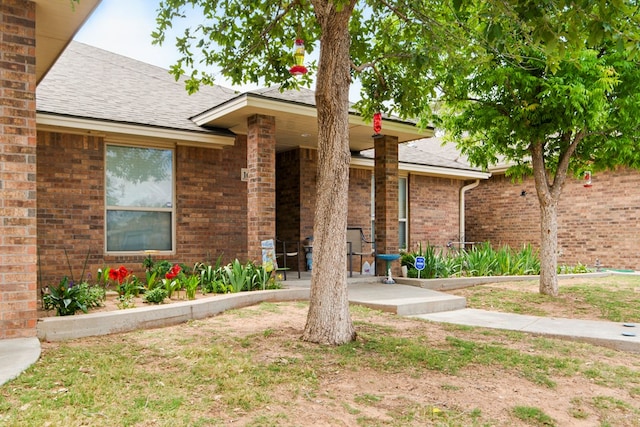 1601 Monterrey Dr, Midland, TX 79703 - view of front of property with roof with shingles, a porch, and brick siding