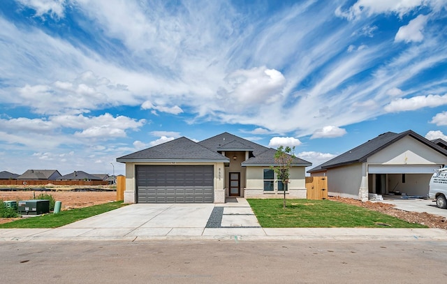 view of front of home featuring a garage and a front yard