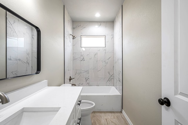 full bathroom with toilet, vanity, and tiled shower / bath