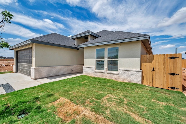 prairie-style house with a front lawn and a garage