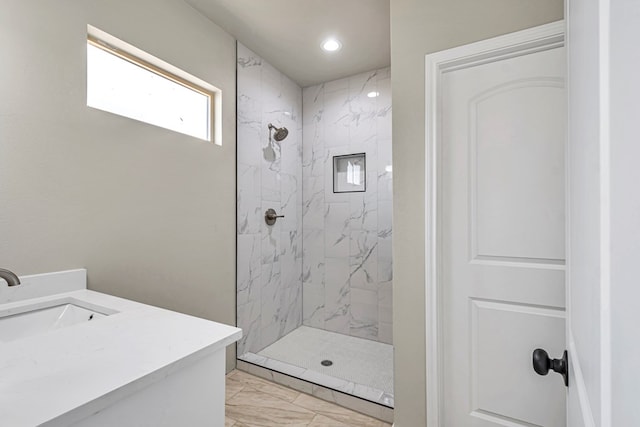 bathroom with vanity and tiled shower