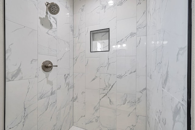 bathroom with a tile shower