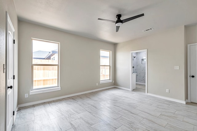 unfurnished bedroom with ceiling fan and connected bathroom