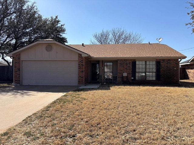 ranch-style home with a garage, a front yard, concrete driveway, and brick siding