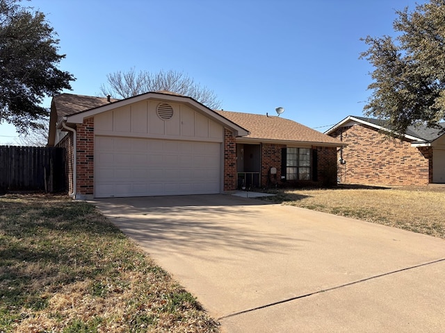 single story home with a garage, concrete driveway, roof with shingles, fence, and brick siding