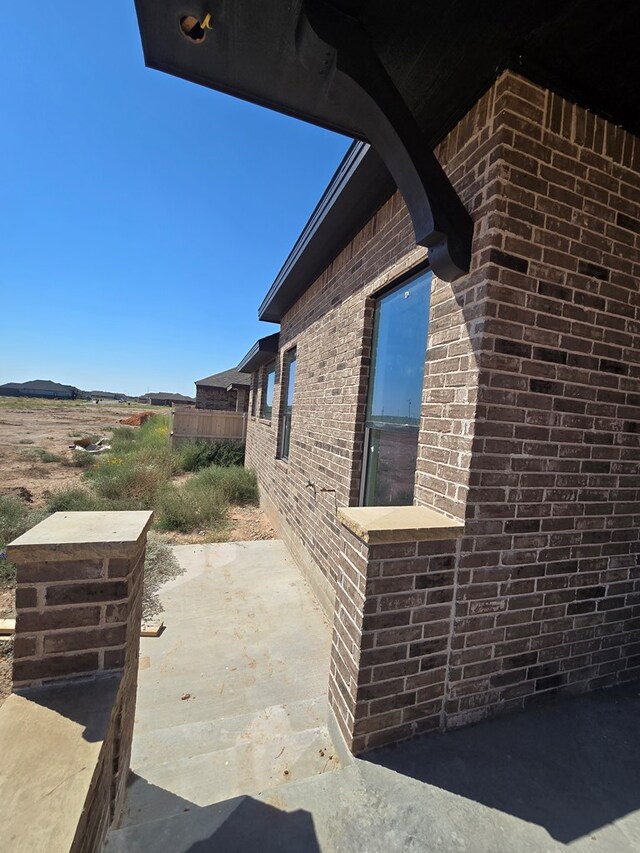 view of side of home featuring a patio area